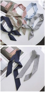 Detailed view of stylish polka dot silk scarves in five colors for hair or bag handles