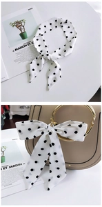 French chic black polka dot silk scarf tied on a beige ring handle bag for decoration