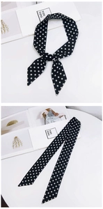 French style polka dot silk scarf detail showing black and white pattern and elegant tie