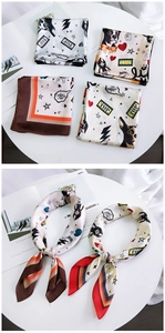 Detailed view of square silk scarves with cartoon french bulldog and star print patterns