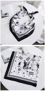 Detail of Boston Terrier print silk scarf with stars and hearts pattern in black and white