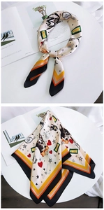 Detailed view of square silk scarf with cartoon Boston Terrier print and TOP typography