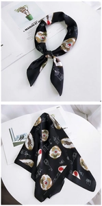 Detail view of square black satin scarf featuring colorful cartoon squirrel patterns