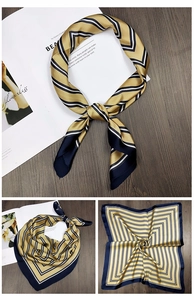 Close-up of golden and navy striped square silk scarf with elegant satin finish