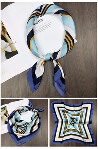 Macro view of silky square scarf with geometric V-pattern in navy blue and yellow