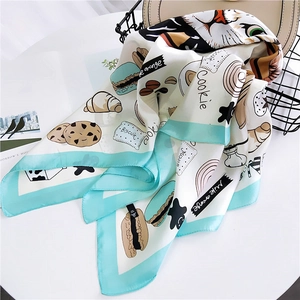 Cartoon animal print square silk scarf with mint green borders on a white table