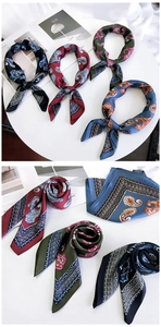 Close-up of four classic paisley silk scarves in navy, burgundy, green and blue colors