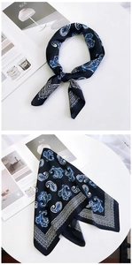 Detail of navy blue paisley silk scarf with satin finish and fashion magazine props
