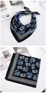 Detail of navy blue paisley silk square scarf showing pattern and draped texture