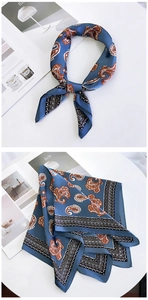 Detailed view of square blue paisley silk scarf with vintage pattern and geometric borders