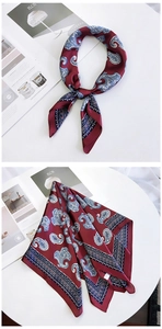 Macro shot of silk-like satin square scarf with vintage wine red paisley patterns