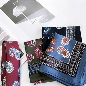 Assorted paisley print square silk scarves in burgundy, olive green, and deep blue colors