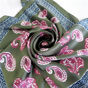 Olive green paisley silk square scarf with pink floral patterns on a white background