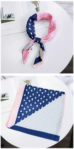 Detail of floral silk scarf featuring navy and pink flower patterns with white stripes