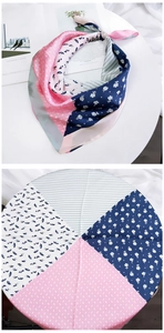 Detail of floral and striped patchwork square silk scarf on a white table with magazine