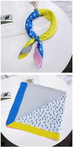 Close-up of a floral pattern silk scarf with geometric patchwork and blue flower print
