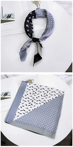 Silk scarf with floral and geometric patterns on a minimalist table display