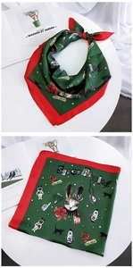 Detail of dark green satin scarf featuring space rabbit illustration and red border