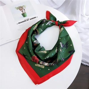 Chic 70cm silk scarf with green and red contrast print on white table with a magazine
