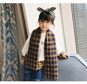 Detail of yellow and blue plaid knit scarf and matching bow headband for kids