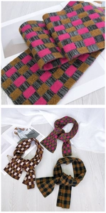 Close-up of checkerboard knit scarf textures in magenta, yellow, and grey patterns