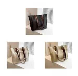 Detail view of canvas tote bags in black, beige, and khaki with leather shoulder straps