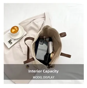 Internal view of large beige canvas tote bag showing spacious storage for daily items