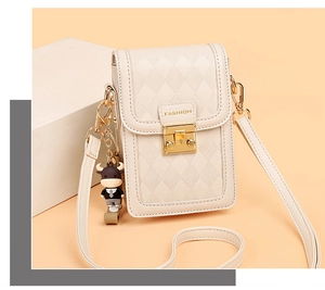 Close-up of quilted leather phone bag with gold hardware and cartoon cow charm detail