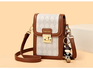 Detail of quilted texture, gold clasp, and cute calf charm on a contrast crossbody bag