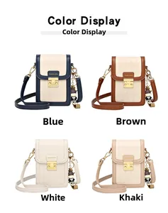 Detail view of the quilted pattern flap and golden metal clasp on a mini crossbody bag
