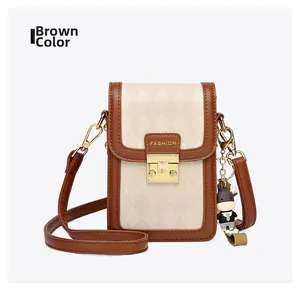 Detail of brown PU leather crossbody phone bag with quilted texture and gold lock