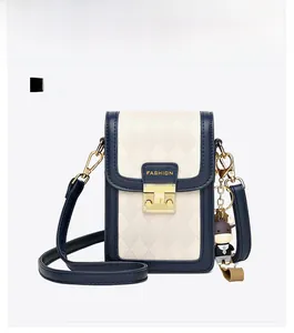 Front view of quilted crossbody phone bag with gold clasp and cartoon bull pendant
