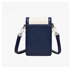 Detail view showing the back of the blue and beige quilted leather crossbody phone bag