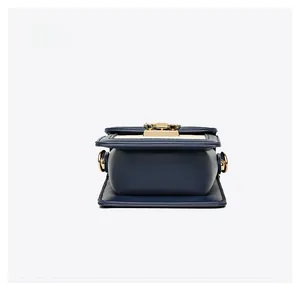 Bottom view of a textured rhombic crossbody bag with smooth stitching and golden metal hardware