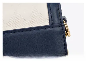 Detail of blue lychee leather and white quilted fabric with reinforced stitching