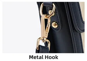 Detail of the golden metal hardware hook and D-ring on dark blue leather bag