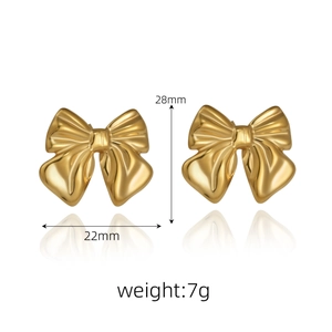Detailed view of golden bow earrings showing 28mm by 22mm dimensions and polished texture