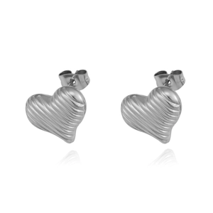 Macro detail of silver heart stud earrings with textured finish and butterfly backings