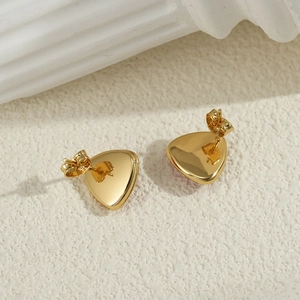 Minimalist golden triangle stud earrings with 18K gold plating on a textured background