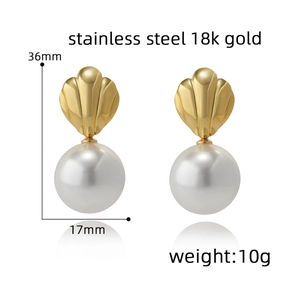 Detail view of 18k gold shell earrings with dimensions 36mm by 17mm and 10g weight