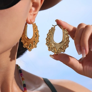 Golden oversized geometric hollow hoop earrings with bohemian relief pattern