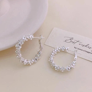 Elegant silver textured C-shaped hoop earrings featuring a unique hammered crushed silver design