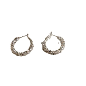 French minimalist silver C-shaped earrings with crushed silver texture and irregular finish
