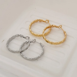 Fashionable gold and silver large hoop earrings with textured wavy geometric design