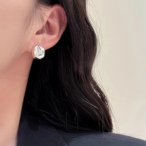 Minimalist S925 silver studs with irregular concave-convex ball texture on model