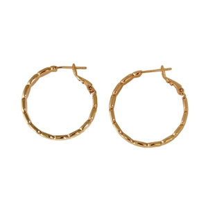 Exaggerated golden bamboo joint geometric hoop earrings with polished metallic finish
