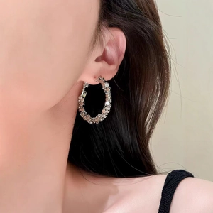 Chunky silver sparkle hoop earrings with textured scale design for a bold look