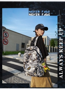 Street style shot of a black and white manga print backpack with a green crocodile charm