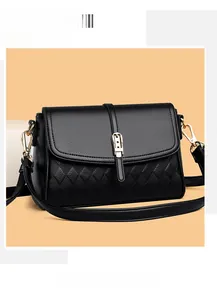 Close-up of black litchi grain leather bag with rhombus pattern and gold buckle