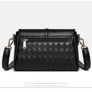 Rear view of black quilted leather crossbody bag featuring a golden zipper back pocket